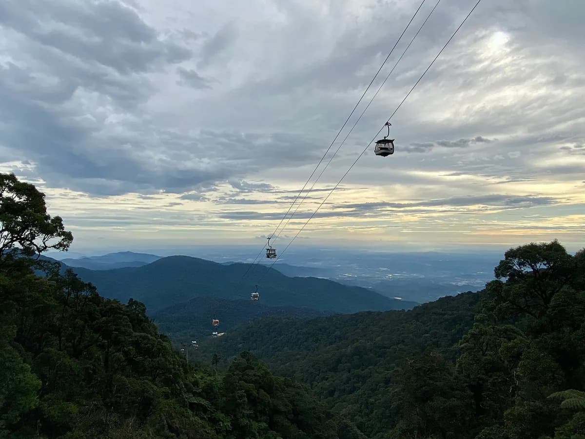 Genting Skyway cable cars crossing forested mountains above the plains below Genting Highlands